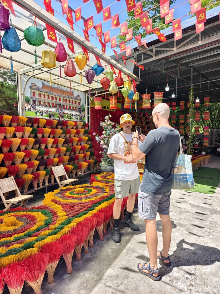 Tourists exploring colorful Thuy Xuan Incense Village via Hue Travel Cars private car rental